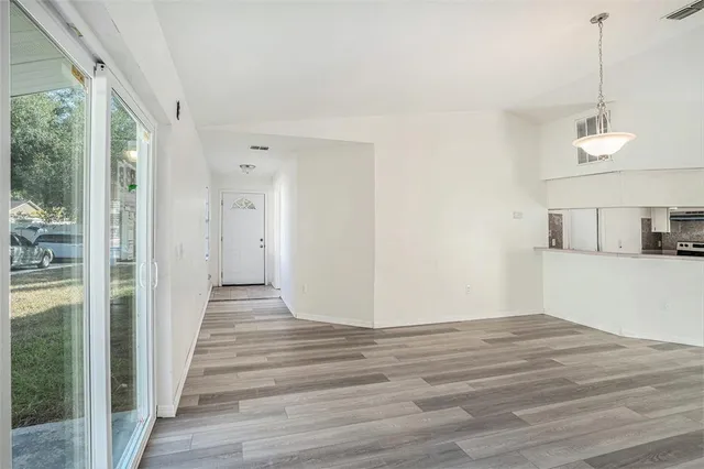a view of a room with wooden floor and white walls