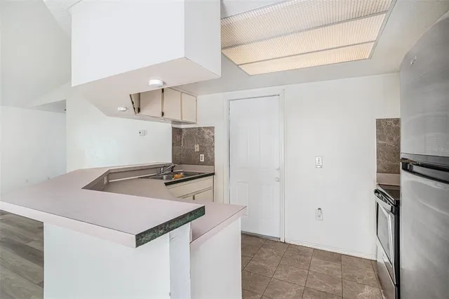 a kitchen with stainless steel appliances a refrigerator and a stove