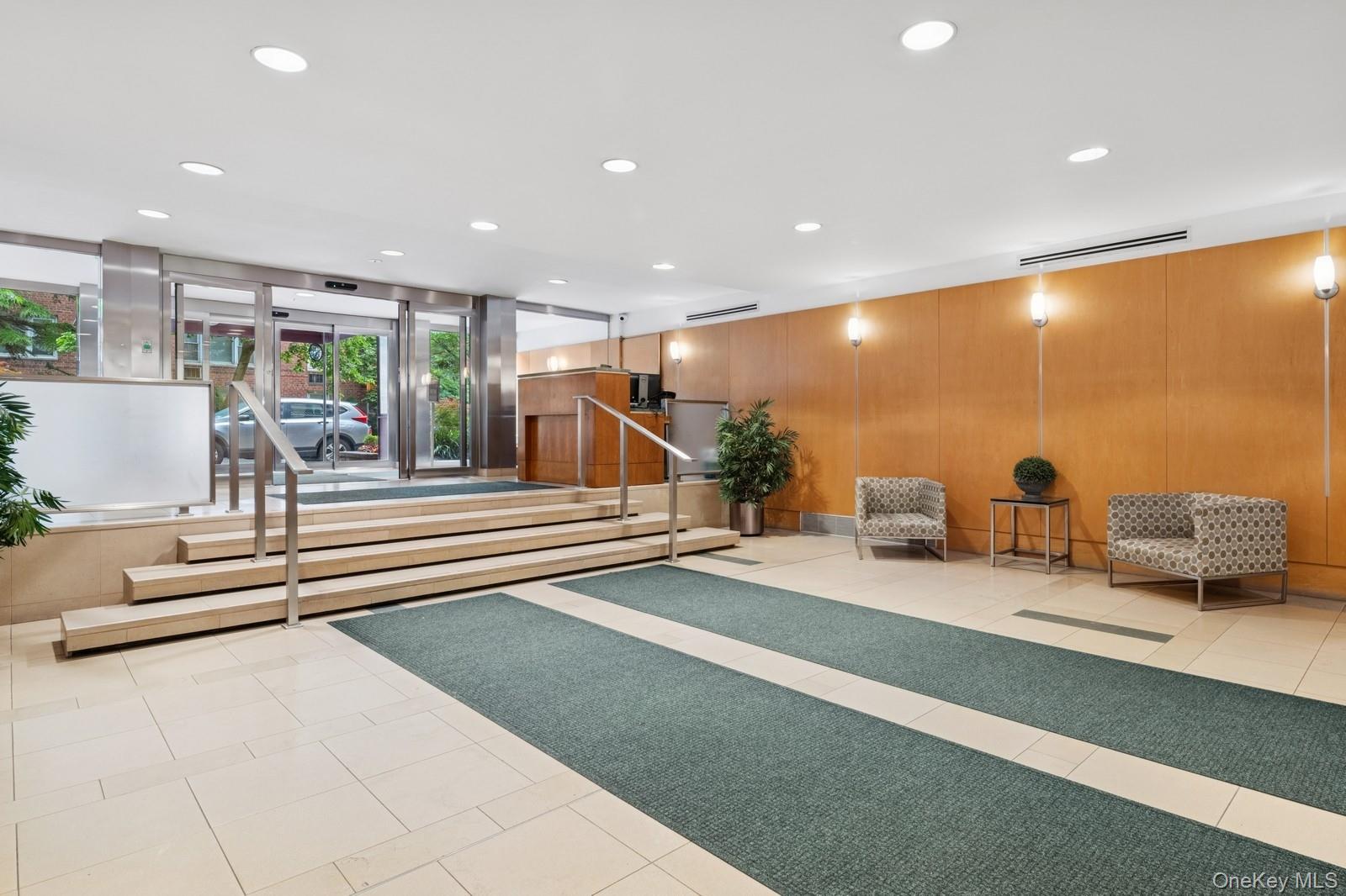 110-20 71st Road, Unit 216 Queens, NY 11375 - Photo 14 of 14 a lobby with furniture and a potted plant