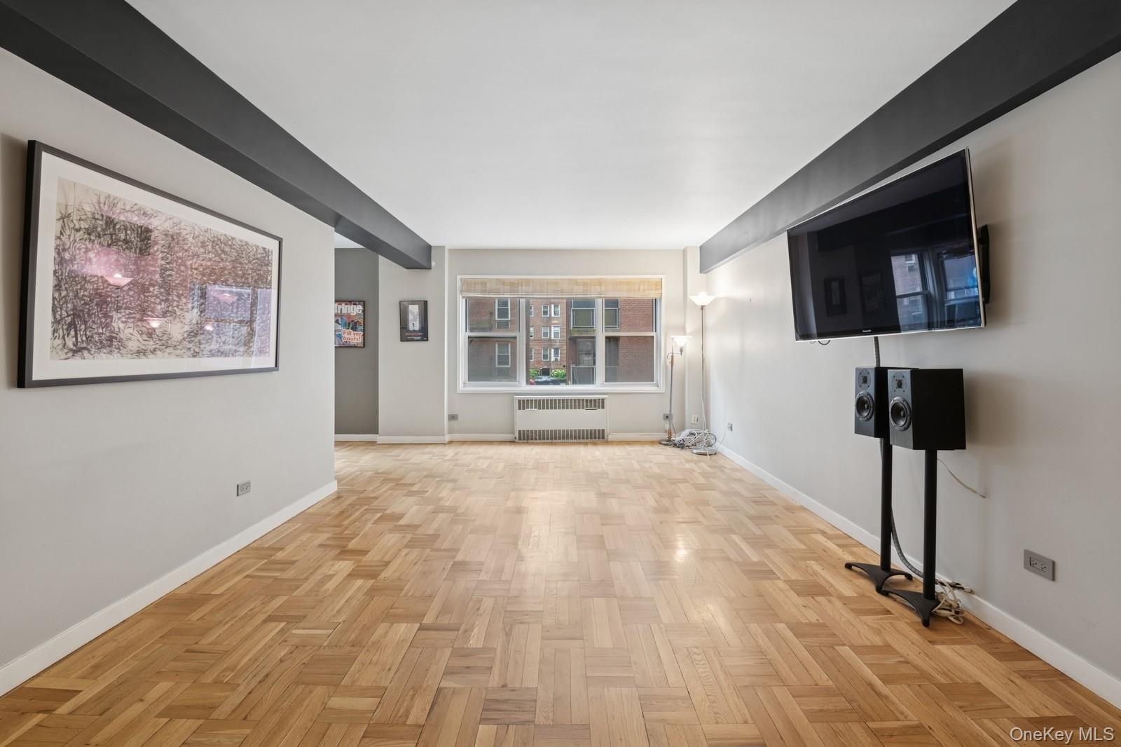 110-20 71st Road, Unit 216 Queens, NY 11375 - Photo 6 of 14 a view of an empty room with a window