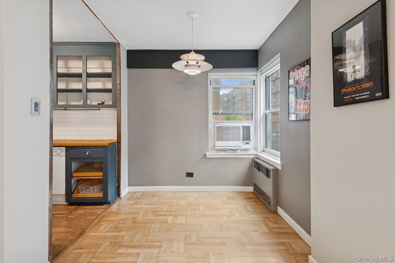 110-20 71st Road, Unit 216 Queens, NY 11375 - Photo 9 of 14 a view of an empty room with a window and kitchen view