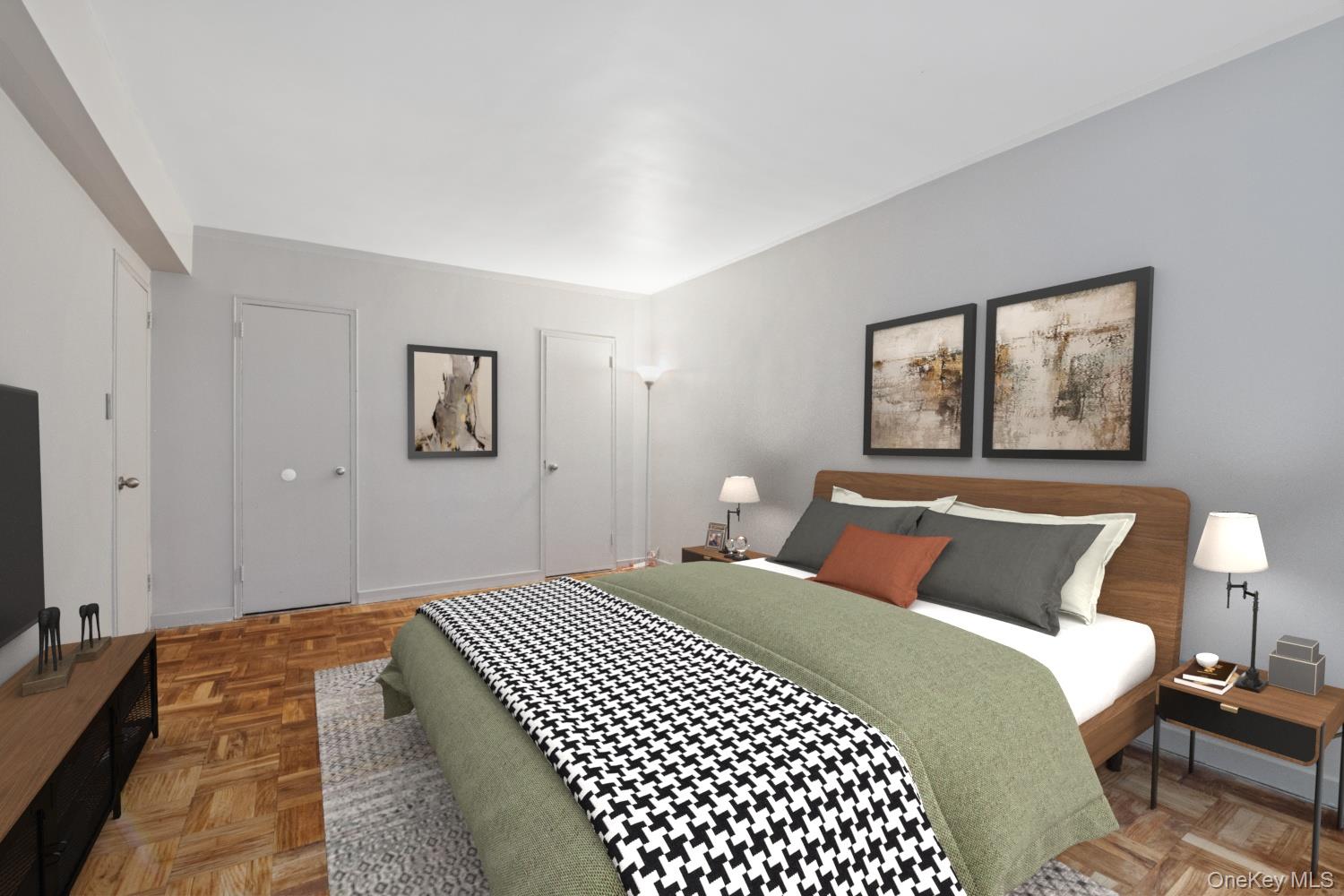 110-20 71st Road, Unit 216 Queens, NY 11375 - Photo 10 of 14 a bedroom with a large bed and a lamp on dresser