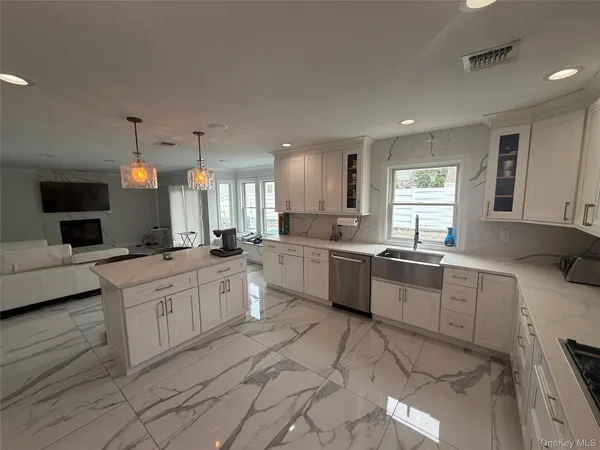 a spacious bathroom with a granite countertop sink a mirror and a shower