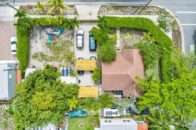 an aerial view of a house with a yard and garden