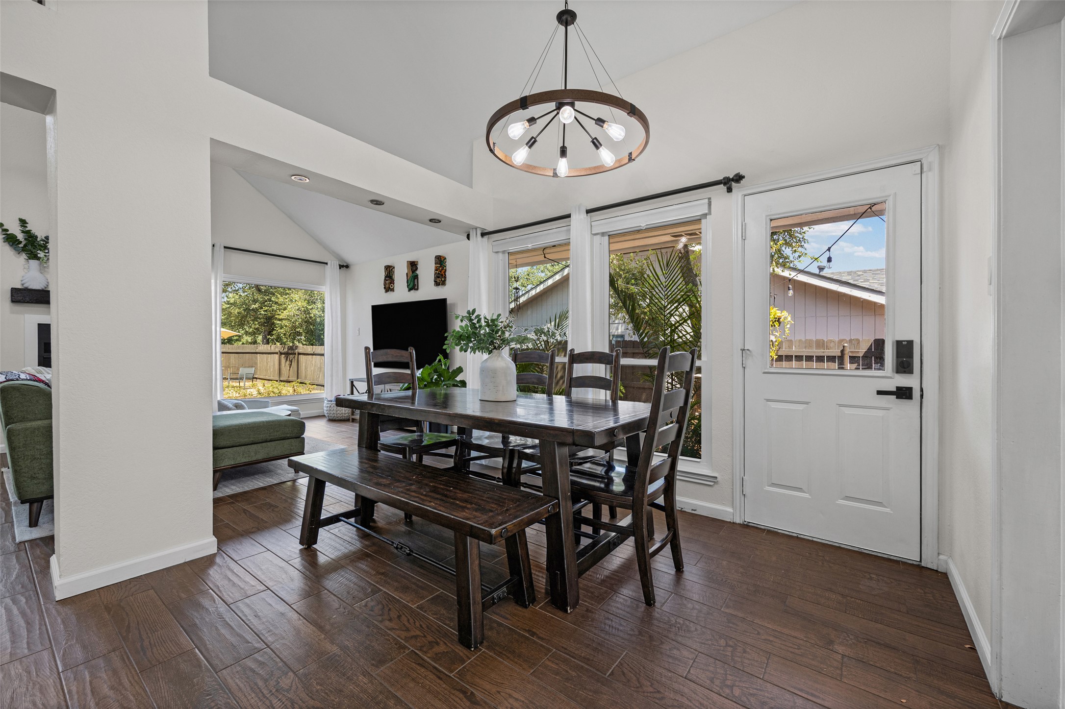 3006 Overland Street Round Rock, TX 78681 - Photo 6 of 29 Rich wood-look flooring and soaring ceilings define this inviting dining space.