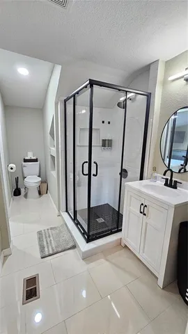 a bathroom with a double vanity sink mirror and shower