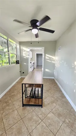 a view of a livingroom with furniture and a ceiling fan