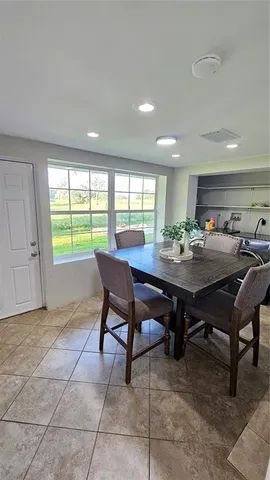 a view of a dining room with furniture and window