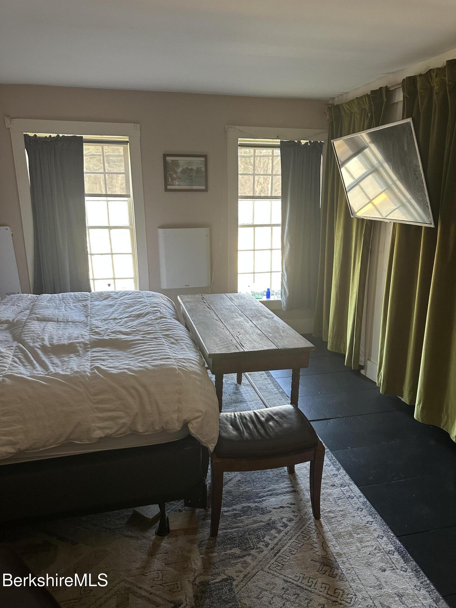 27 North Main Road Otis, MA 01253 - Photo 16 of 24 a bedroom with a bed window and a table in it