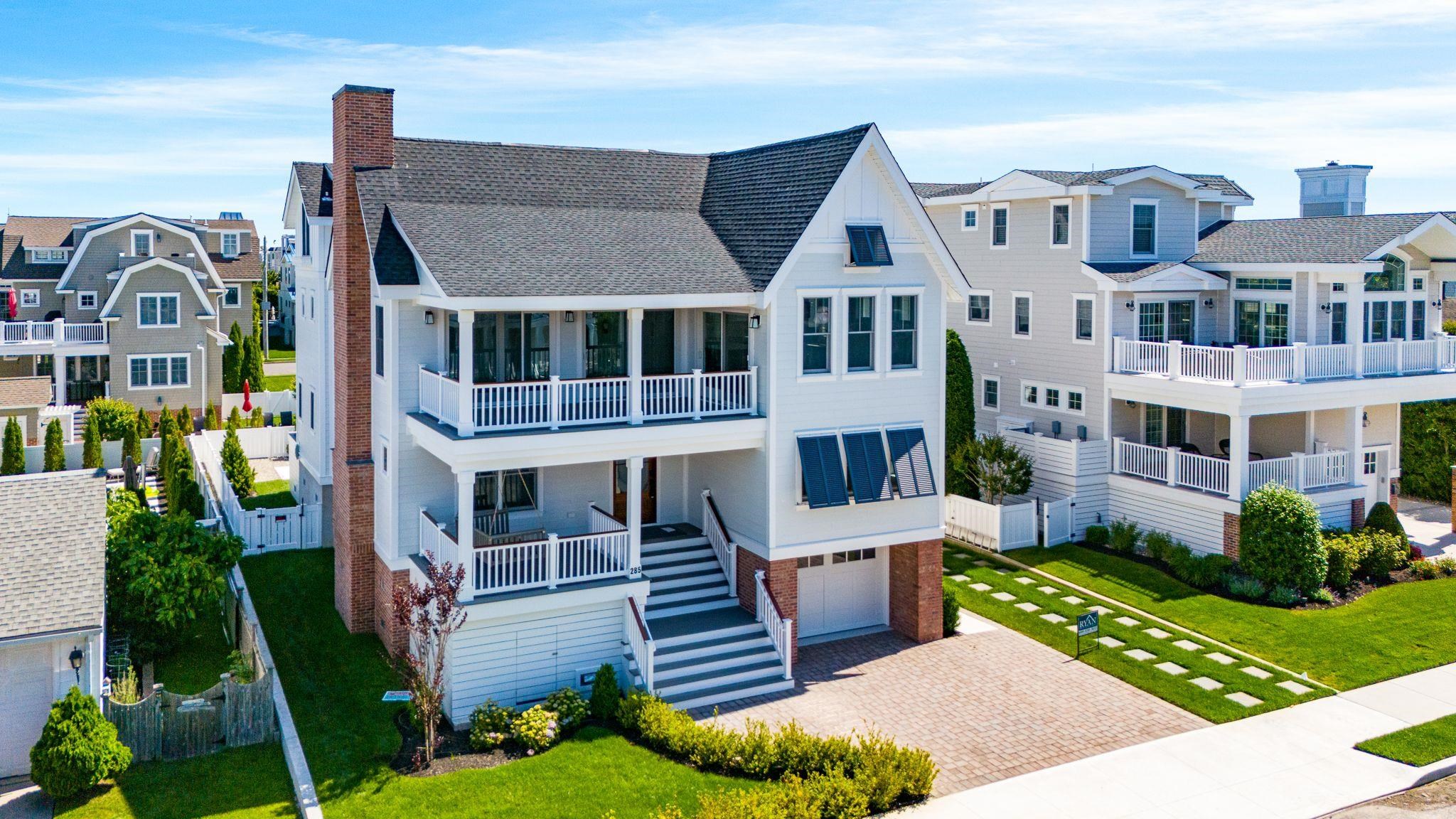 285 58th Street Avalon, NJ 08202 - Photo 1 of 50 a front view of a house with garden