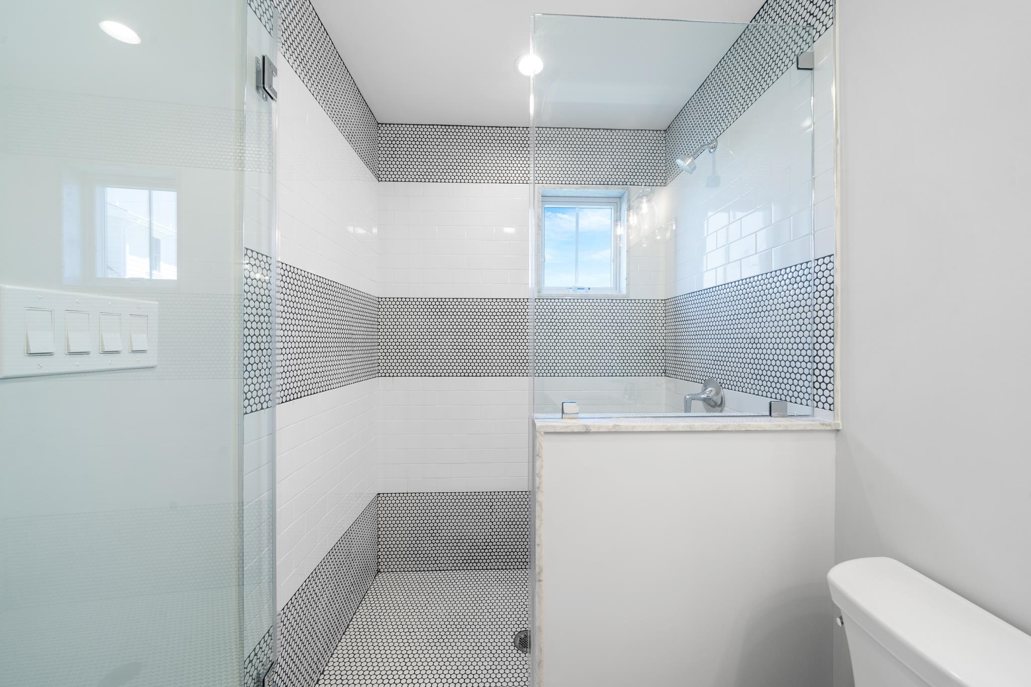285 58th Street Avalon, NJ 08202 - Photo 15 of 50 a bathroom with a sink a toilet and a shower