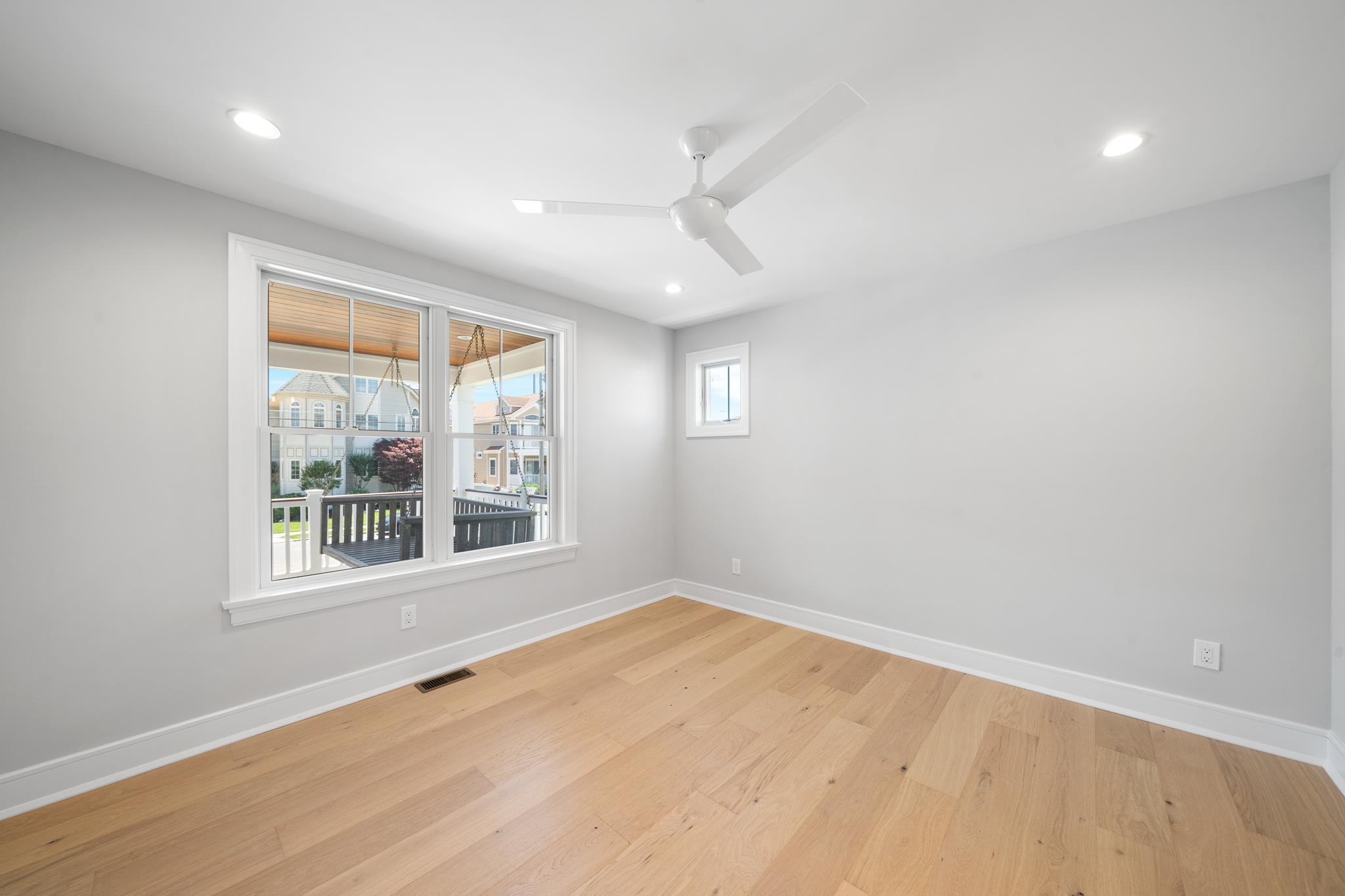 285 58th Street Avalon, NJ 08202 - Photo 17 of 50 an empty room with wooden floor and windows