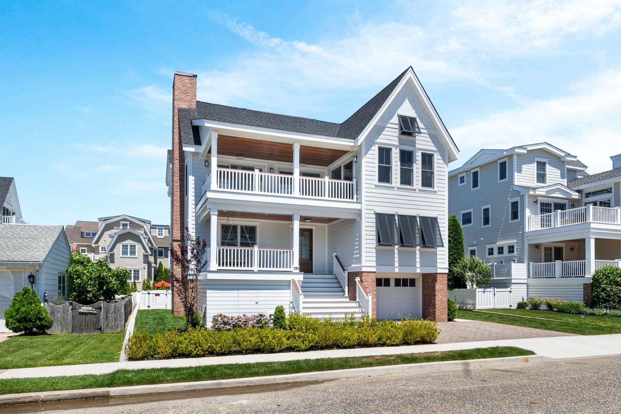 285 58th Street Avalon, NJ 08202 - Photo 2 of 50 a front view of a residential apartment building with a yard