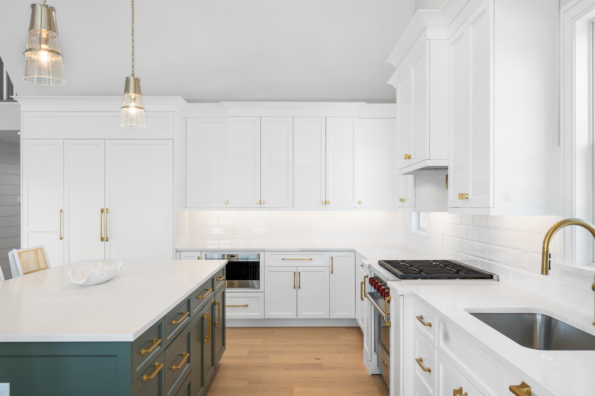 285 58th Street Avalon, NJ 08202 - Photo 30 of 50 a kitchen with a sink stove and white cabinets with wooden floor