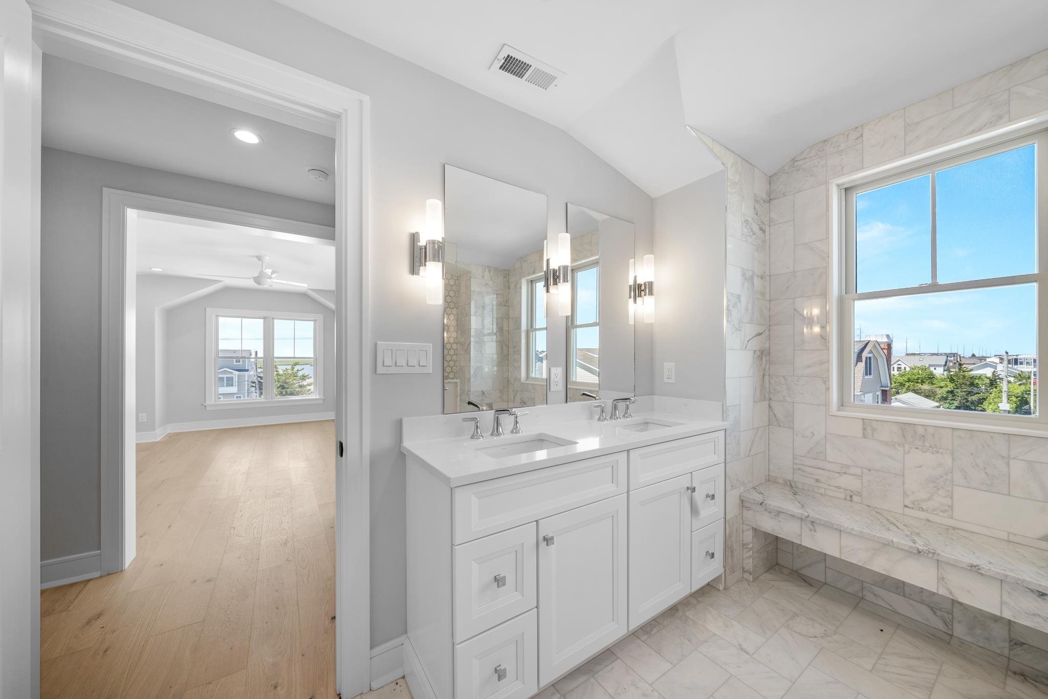 285 58th Street Avalon, NJ 08202 - Photo 34 of 50 a bathroom with a double vanity sink and mirror with shower