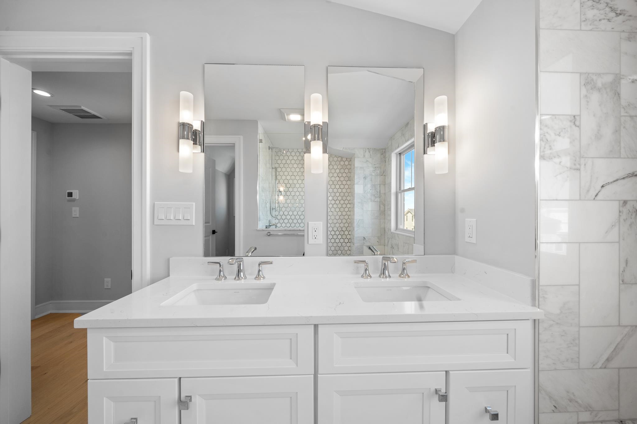 285 58th Street Avalon, NJ 08202 - Photo 35 of 50 a bathroom with a sink and a mirror