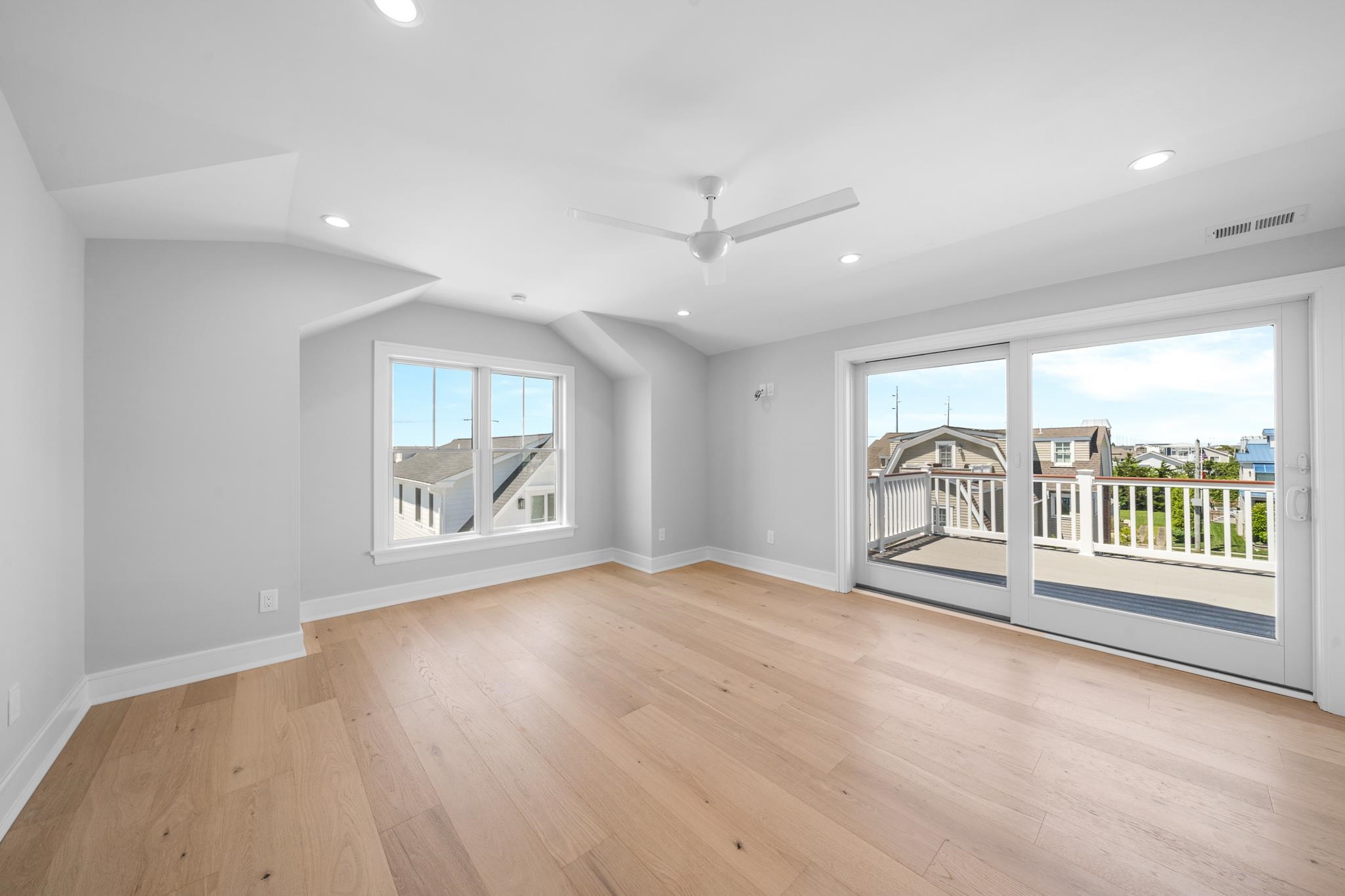 285 58th Street Avalon, NJ 08202 - Photo 38 of 50 a view of an empty room with a window and wooden floor