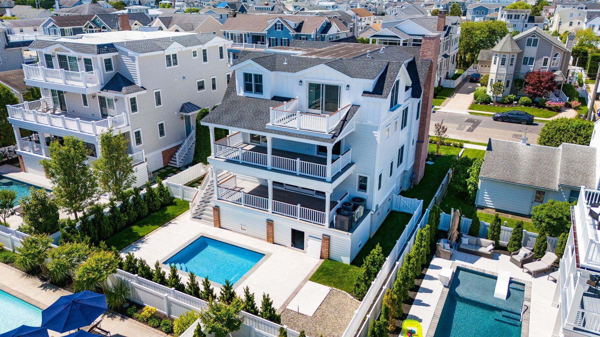 285 58th Street Avalon, NJ 08202 - Photo 4 of 50 an aerial view of multiple houses with a yard