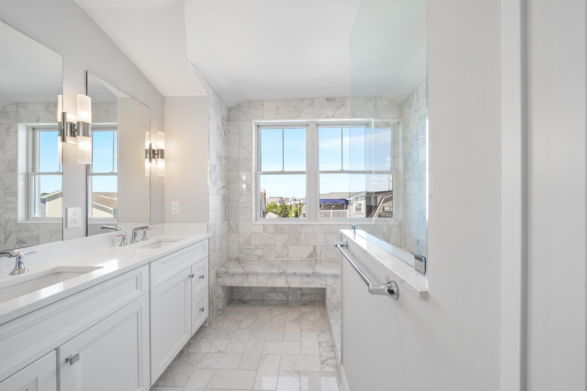 285 58th Street Avalon, NJ 08202 - Photo 41 of 50 a bathroom with a double vanity sink a mirror and a bathtub