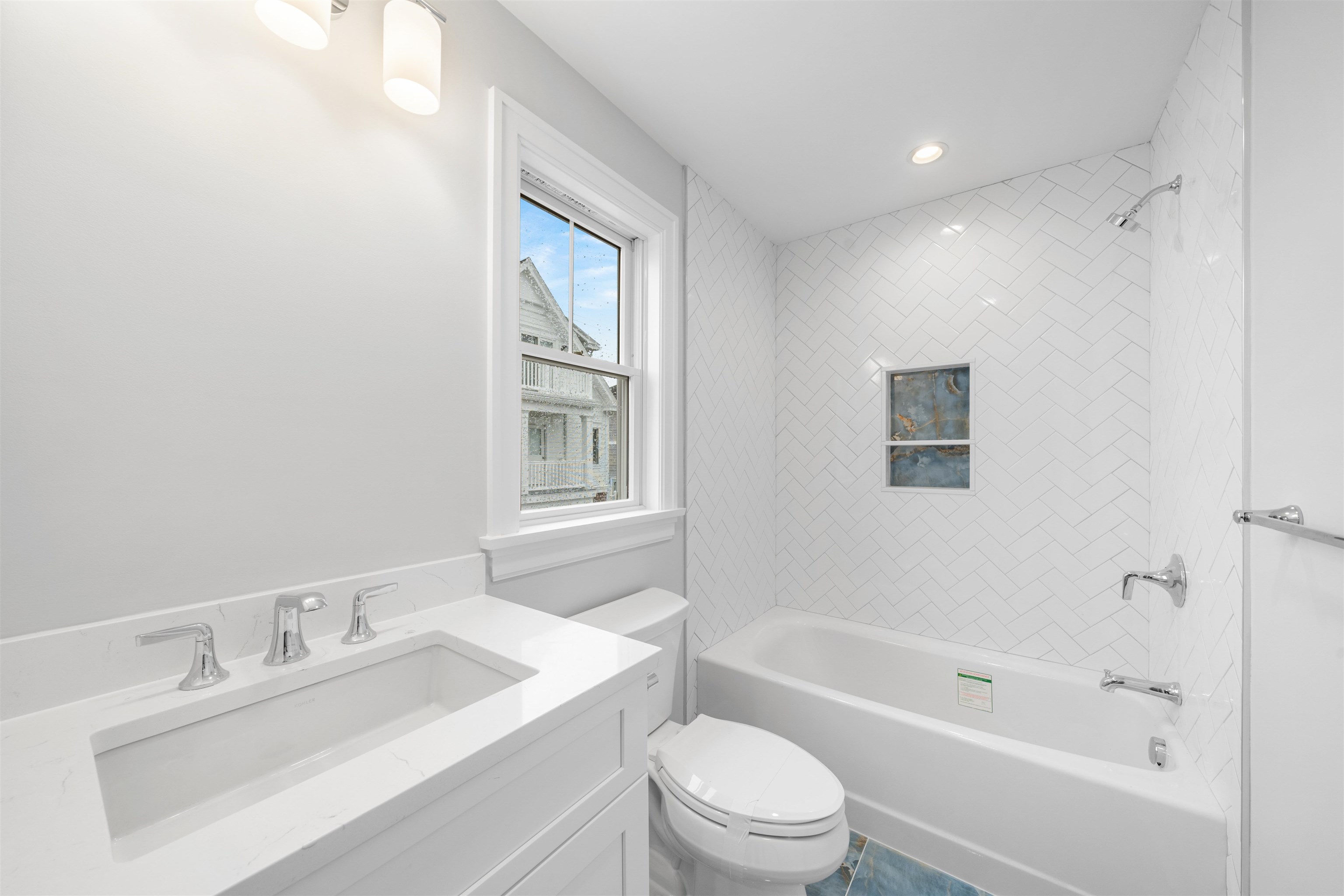 285 58th Street Avalon, NJ 08202 - Photo 46 of 50 a bathroom with a sink toilet vanity and bathtub