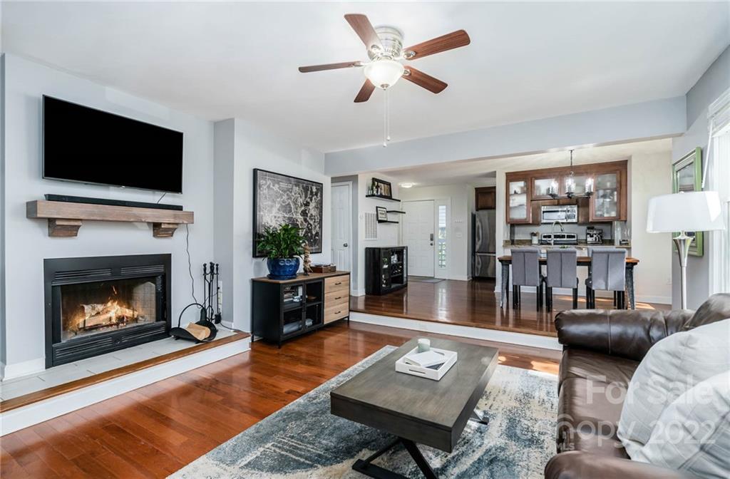 a living room with furniture fireplace and flat screen tv