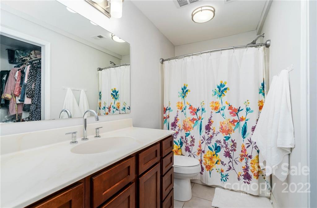308 Queens Road, Unit 29 Charlotte, NC 28204 - Photo 12 of 20 a bathroom with a sink and a curtain