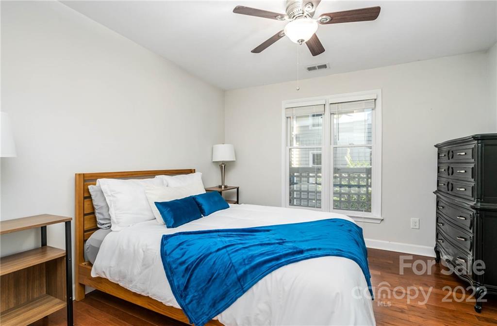 308 Queens Road, Unit 29 Charlotte, NC 28204 - Photo 13 of 20 a bedroom with a bed and a flat tv screen on dresser
