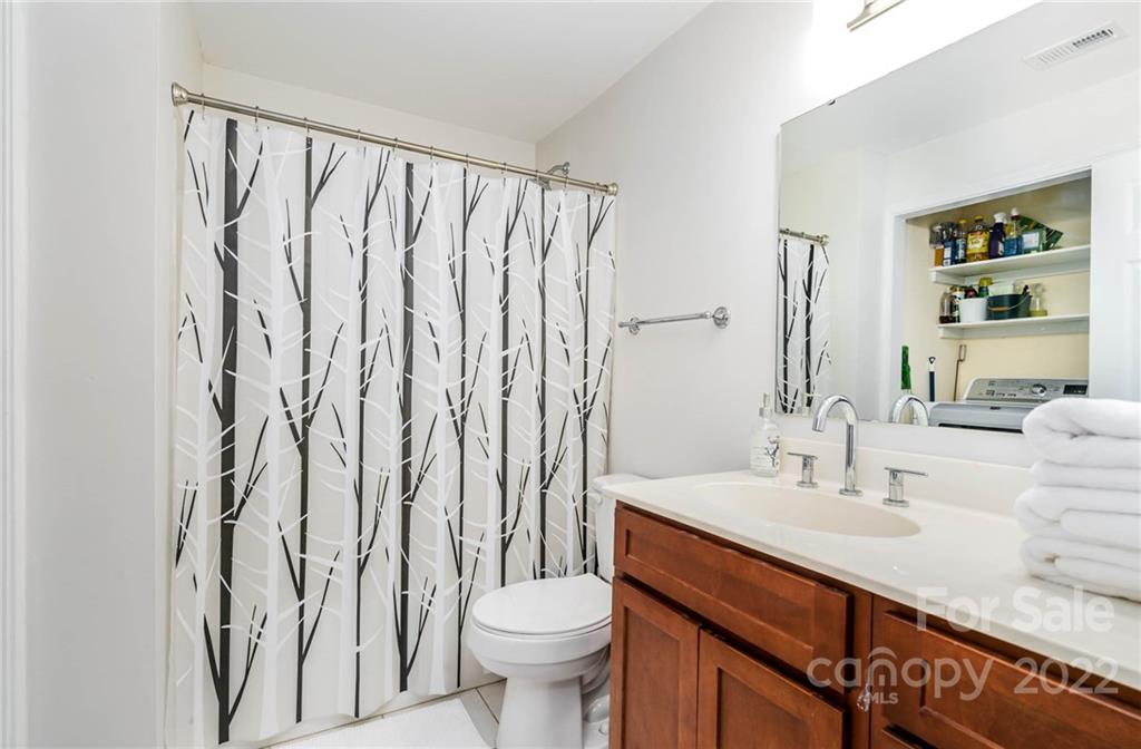 308 Queens Road, Unit 29 Charlotte, NC 28204 - Photo 15 of 20 a bathroom with a sink a toilet and a mirror