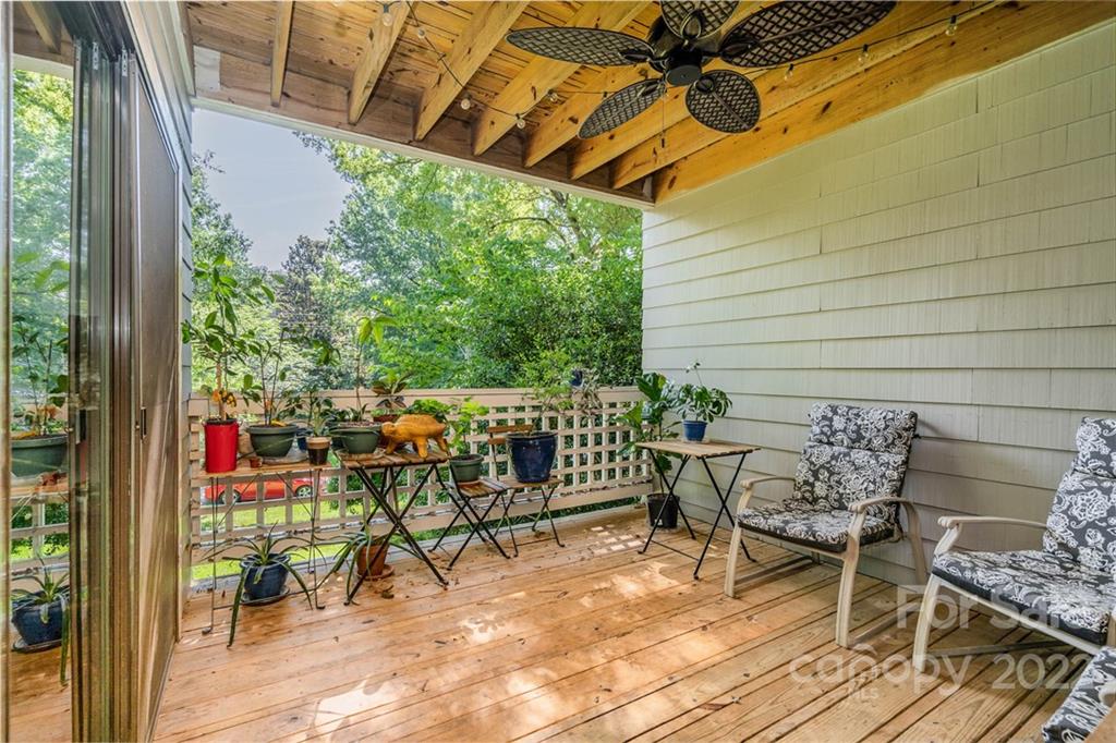308 Queens Road, Unit 29 Charlotte, NC 28204 - Photo 16 of 20 a view of a patio with table and chairs with wooden floor and fence