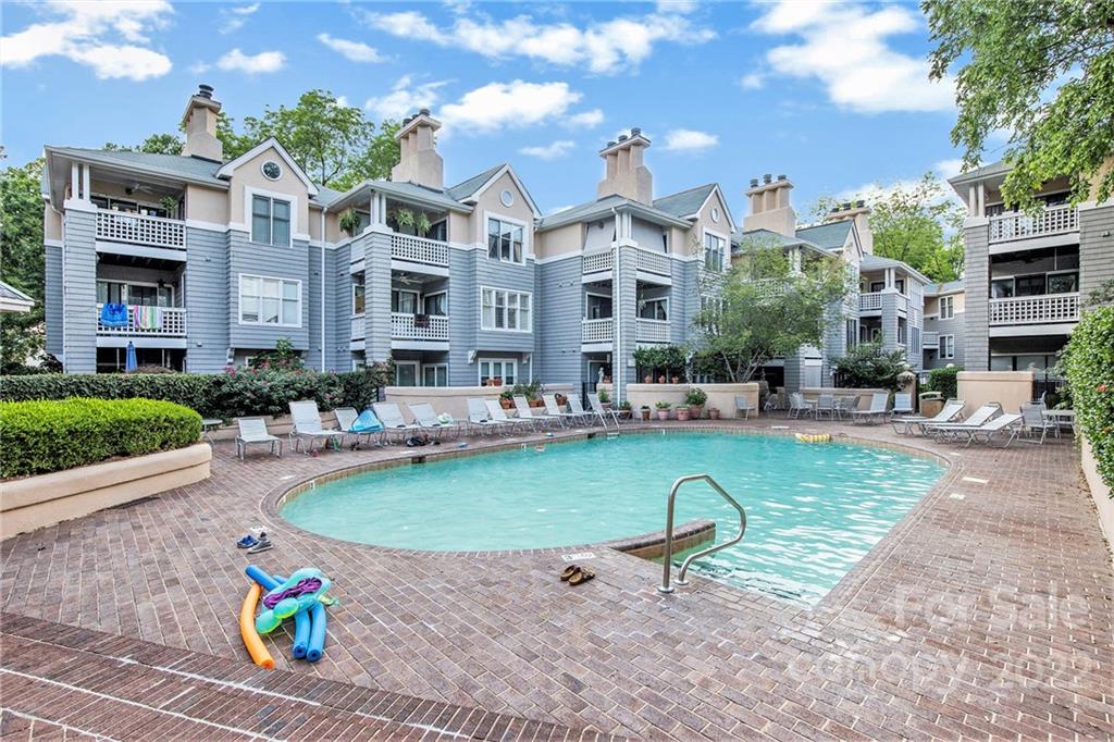 308 Queens Road, Unit 29 Charlotte, NC 28204 - Photo 20 of 20 a view of a house with a swimming pool and sitting area