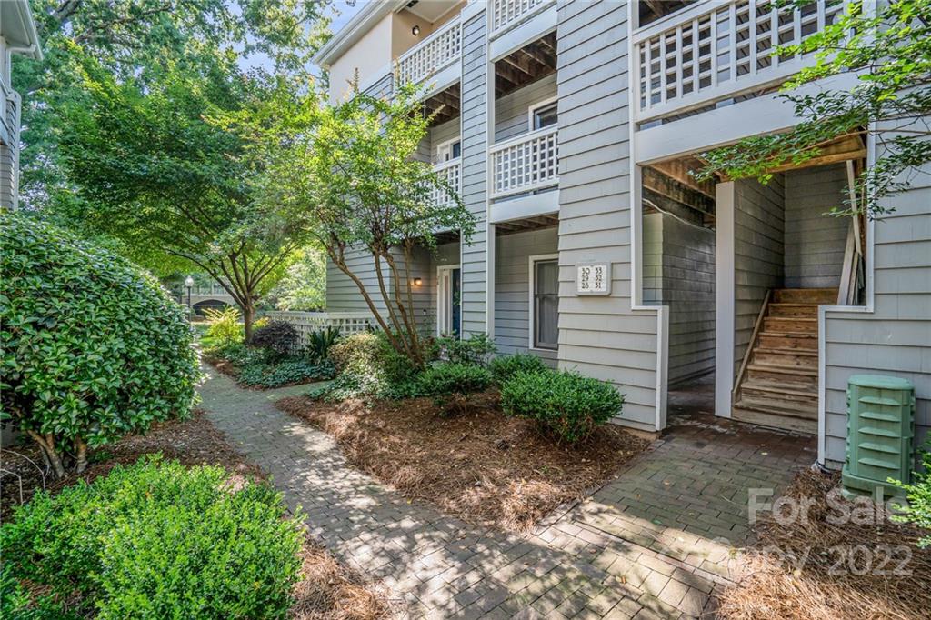 308 Queens Road, Unit 29 Charlotte, NC 28204 - Photo 2 of 20 a view of a house with a yard and plants