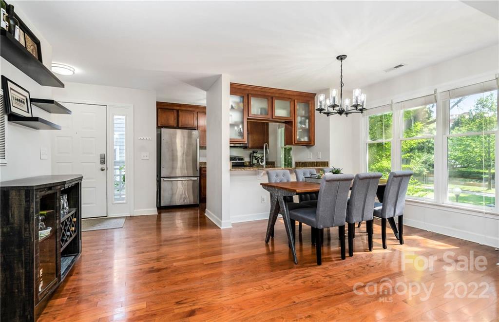 308 Queens Road, Unit 29 Charlotte, NC 28204 - Photo 6 of 20 a view of a dining room with furniture window and wooden floor