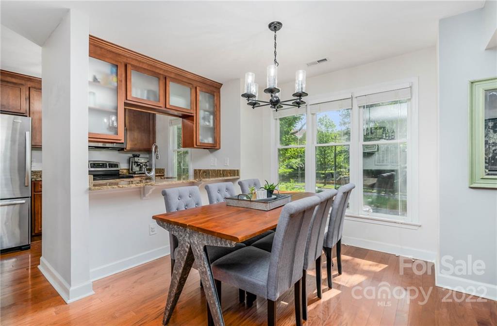 308 Queens Road, Unit 29 Charlotte, NC 28204 - Photo 7 of 20 a view of a dining room with furniture window and wooden floor