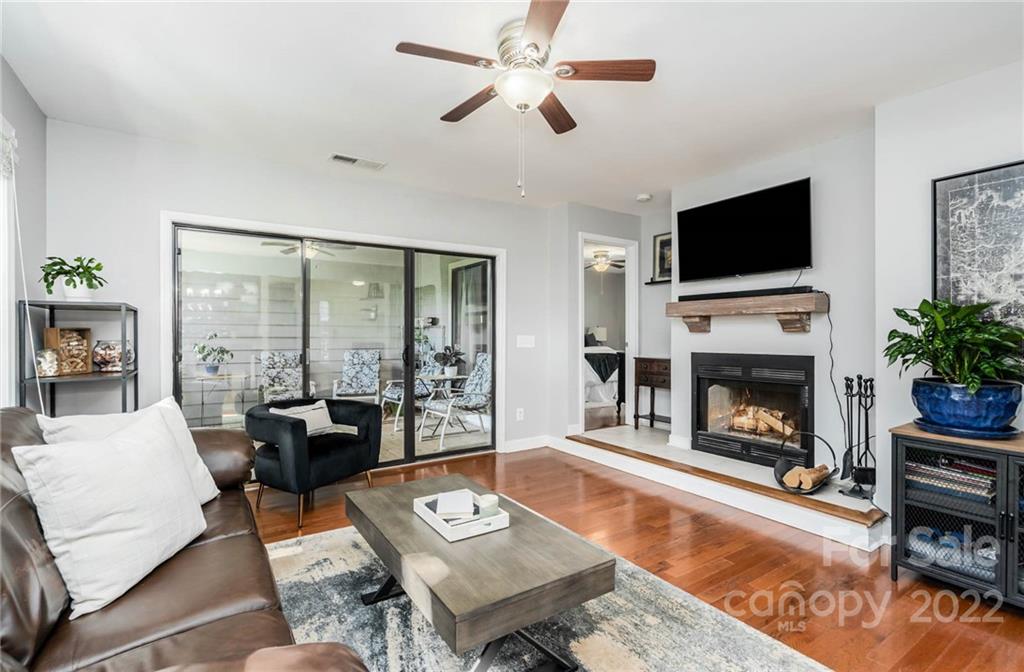 308 Queens Road, Unit 29 Charlotte, NC 28204 - Photo 9 of 20 a living room with furniture a flat screen tv and a fireplace