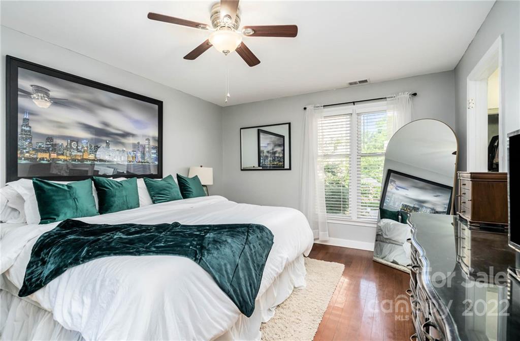 308 Queens Road, Unit 29 Charlotte, NC 28204 - Photo 10 of 20 a bed sitting in a bedroom next to a window