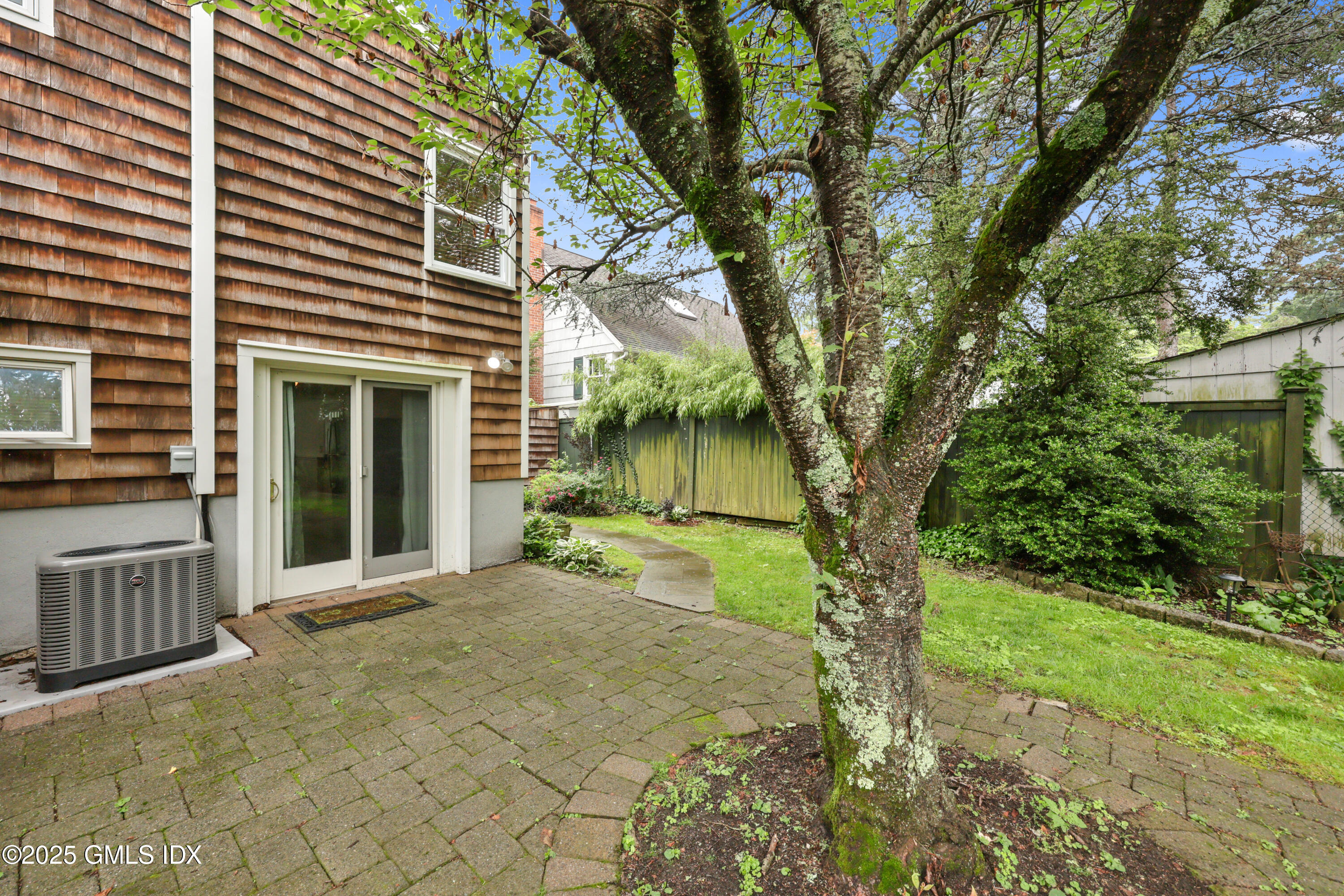 3 Janet Court, Unit 2 Riverside, CT 06878 - Photo 17 of 22 a view of a house with a tree in the yard