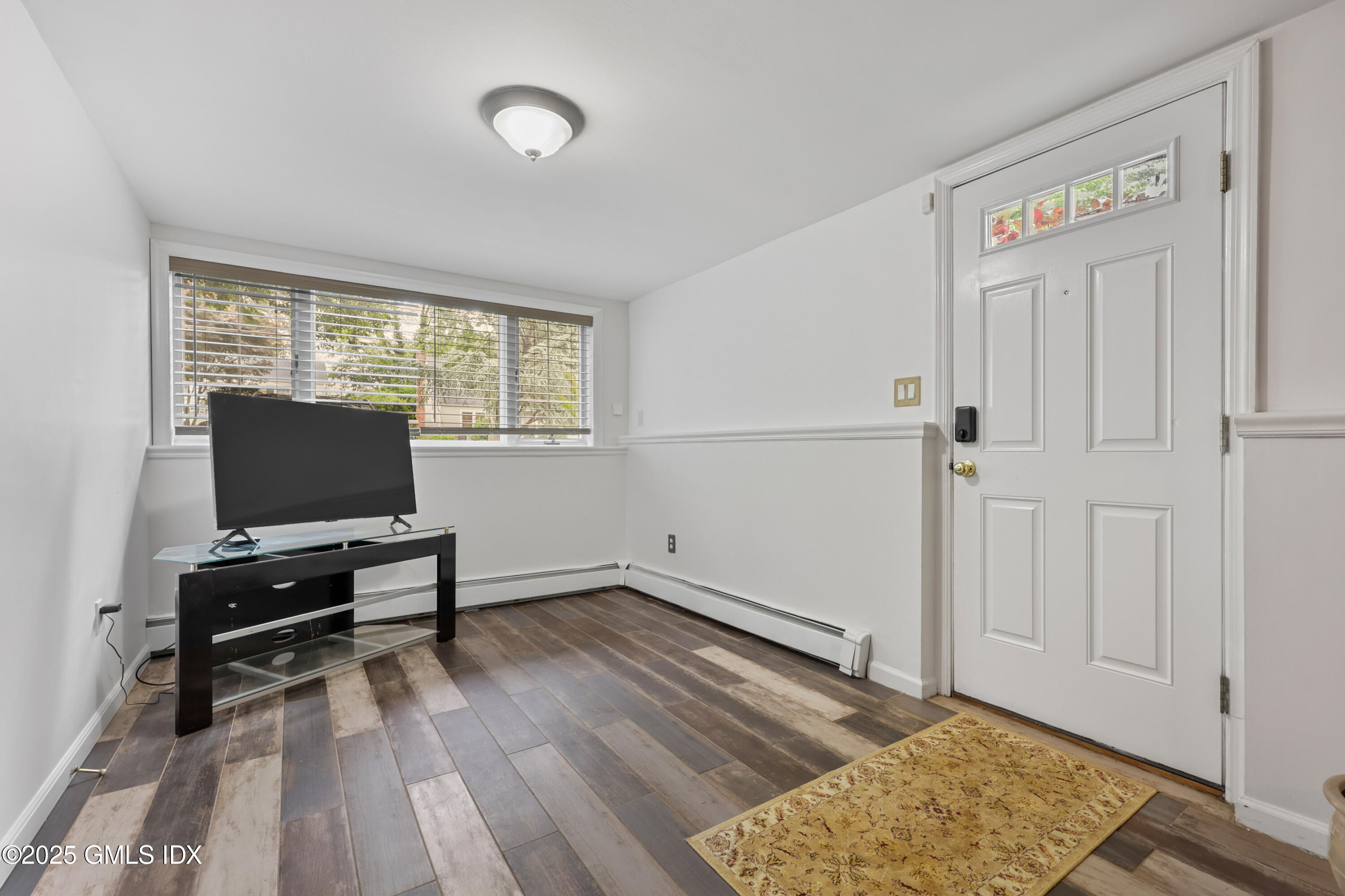 3 Janet Court, Unit 2 Riverside, CT 06878 - Photo 4 of 22 a room with window and a wooden floor
