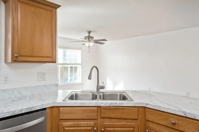 a kitchen with stainless steel appliances granite countertop a refrigerator and a sink