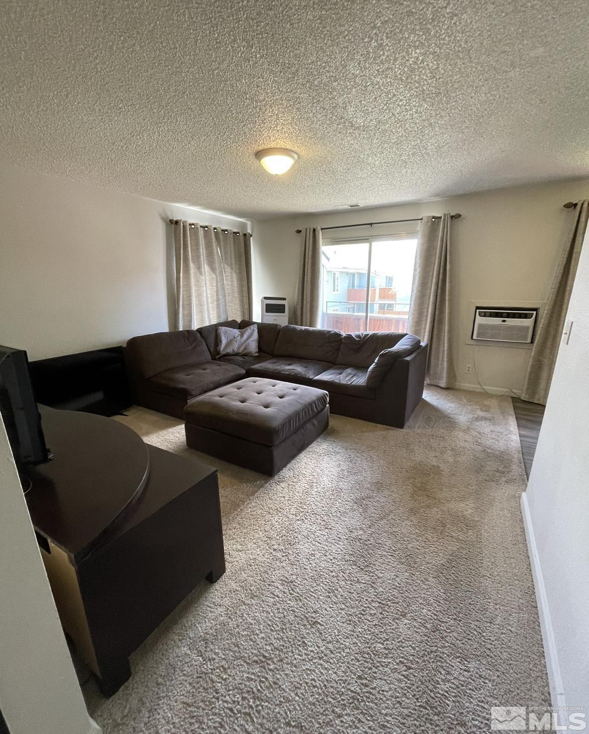4600 Neil Road, Unit 16 Reno, NV 89502 - Photo 3 of 9 a living room with furniture and a window