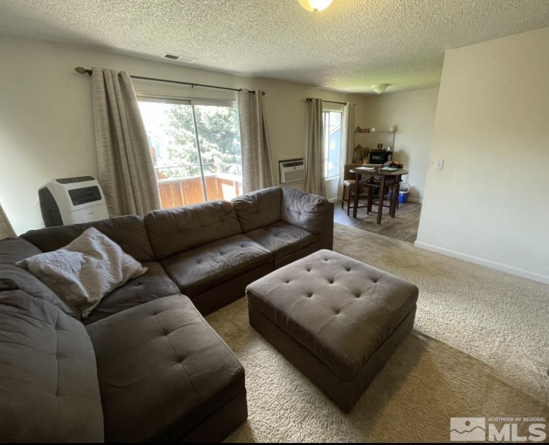 4600 Neil Road, Unit 16 Reno, NV 89502 - Photo 4 of 9 a living room with furniture and a large window