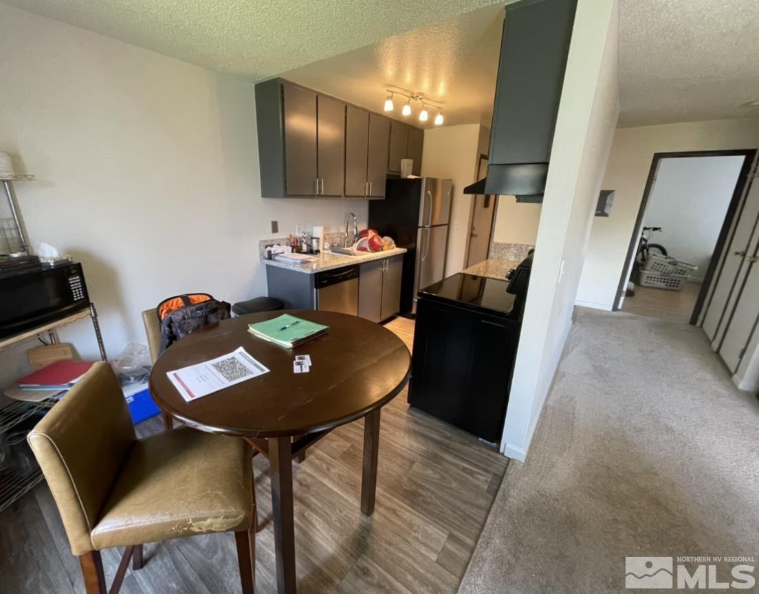 4600 Neil Road, Unit 16 Reno, NV 89502 - Photo 5 of 9 a view of a dining room with furniture and wooden floor