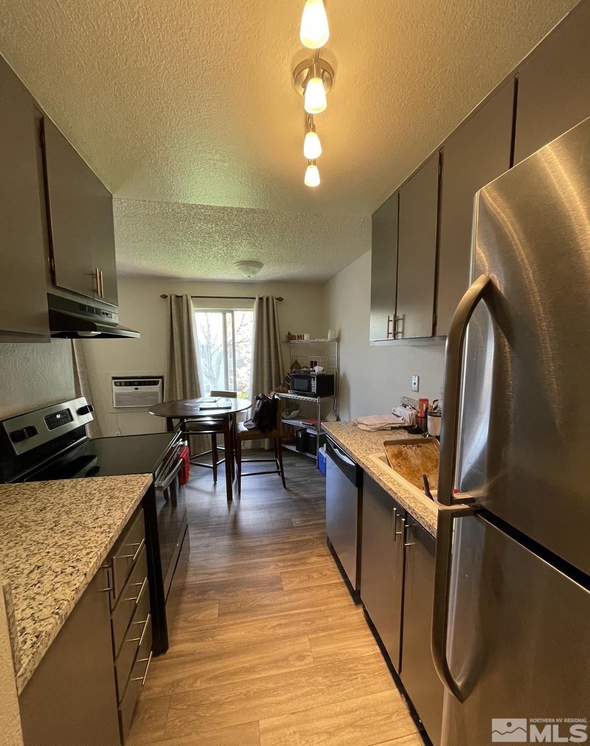 4600 Neil Road, Unit 16 Reno, NV 89502 - Photo 7 of 9 a kitchen with stainless steel appliances granite countertop a sink stove and refrigerator