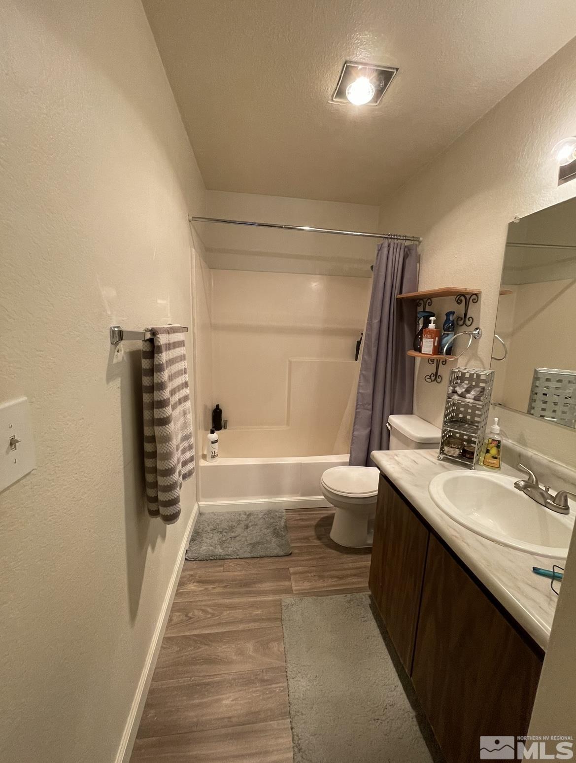 4600 Neil Road, Unit 16 Reno, NV 89502 - Photo 8 of 9 a bathroom with a sink a toilet and tub