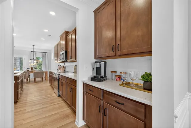 a kitchen with stainless steel appliances granite countertop counter space a sink refrigerator and cabinets