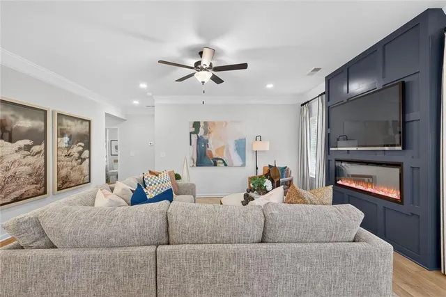 a living room with furniture and a flat screen tv