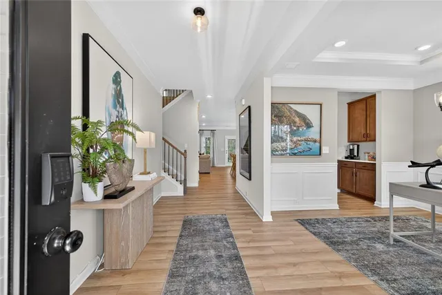 a hallway with wooden floor and white walls