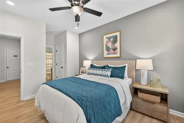 a bedroom with a large bed and a chandelier