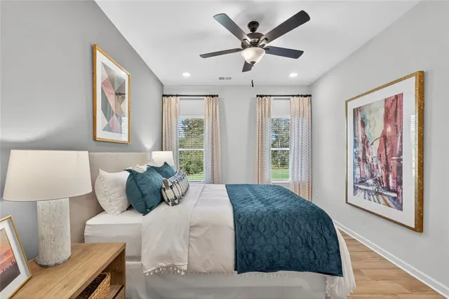 a bedroom with a large bed and a painting on the wall