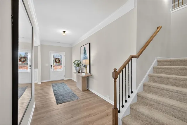 a view of a hallway view with wooden floor and staircase