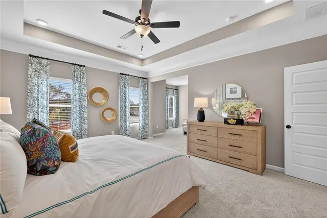 a bedroom with a bed chandelier and dresser